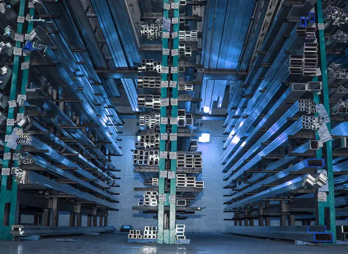 Hundreds of metal extrusions line shelves in the Aluminum Supply Company warehouse.