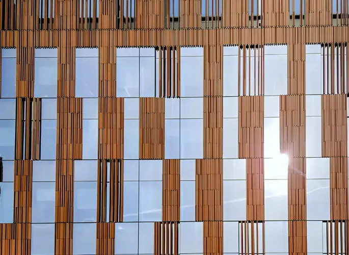 Several windows and metal structures supporting them glint in the sunlight.