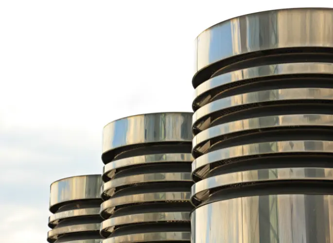 Three architectural columns line a walkway.