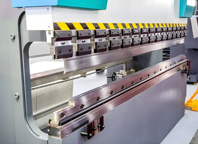 Metal is pressed by a brake forming machine.