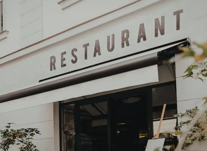 A metal sign made from cut outs reads, "restaurant."