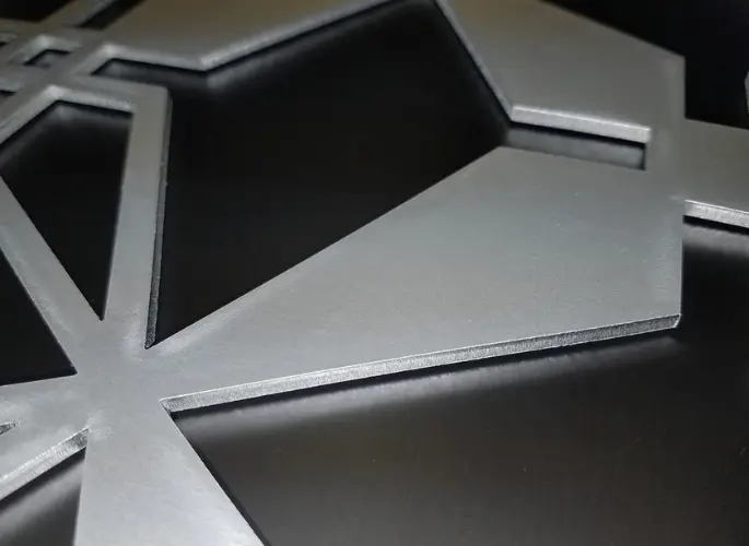 A metal sheet with intricate, geometric cutouts