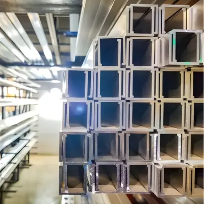 Several glass channel extrusions rest on a shelf.