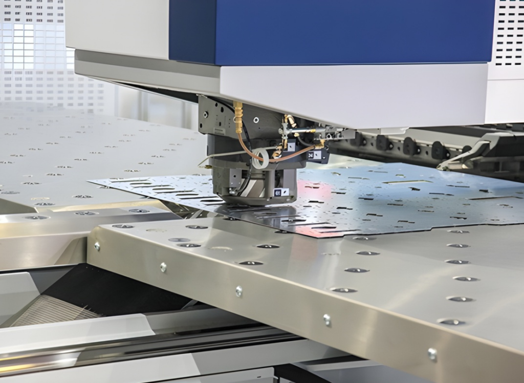 A machine cuts holes out of a metal sheet.