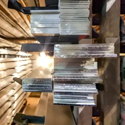 Several rectangular bar extrusions are stacked on a shelf.