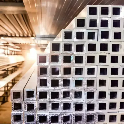 Several square tube extrusions rest on a shelf.