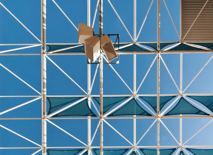 A metal trellis holds up sound equipment.