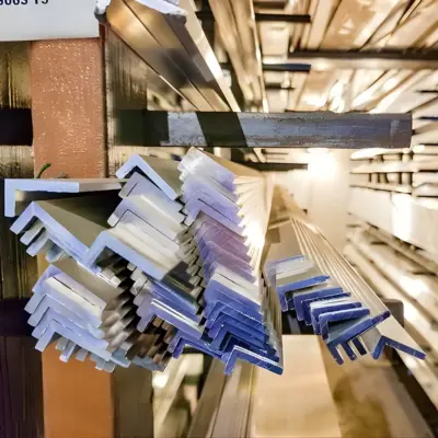 Several unequal angle extrusions are stacked on a shelf.