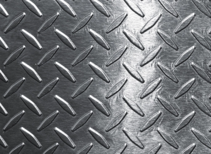 A sheet of aluminum with a diamond plate design