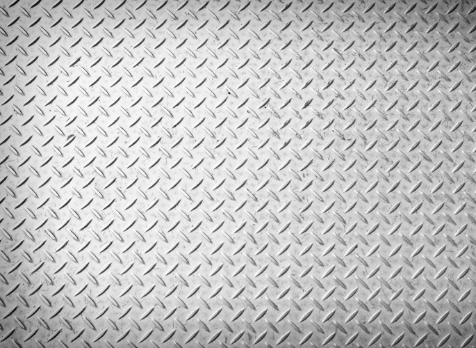 A sheet of aluminum with a diamond plate design