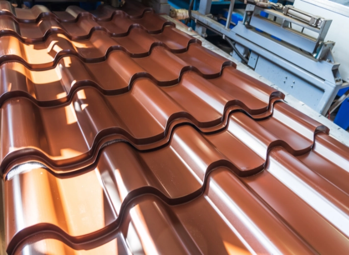 Several wavy pieces of painted steel sheet metal form a roof.